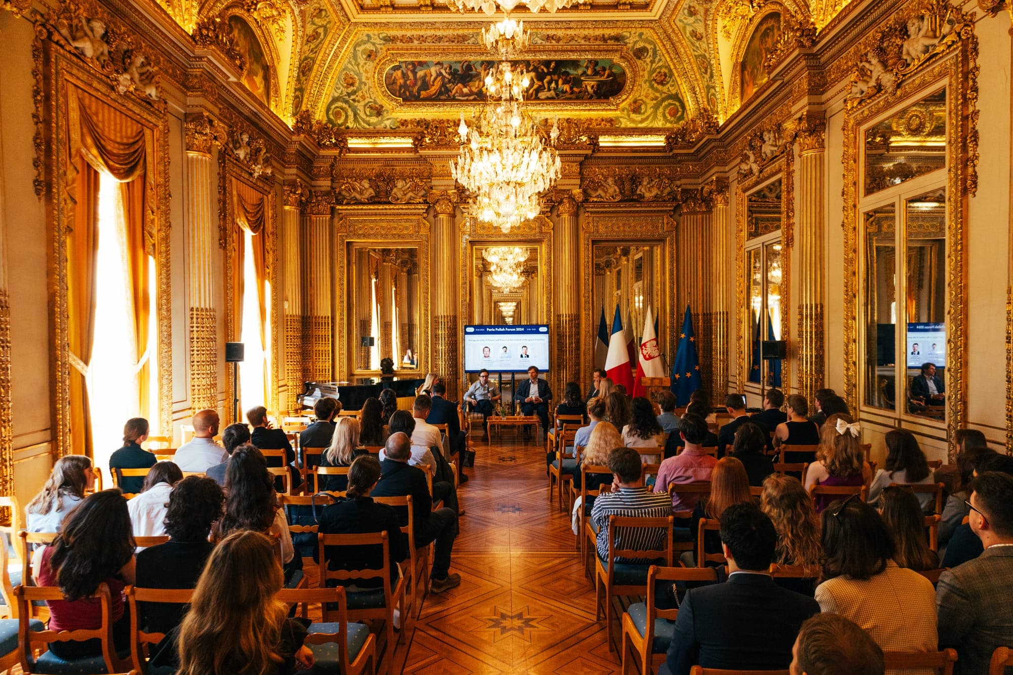 Audience filling a gilded salon during the Paris Polish Forum 2024