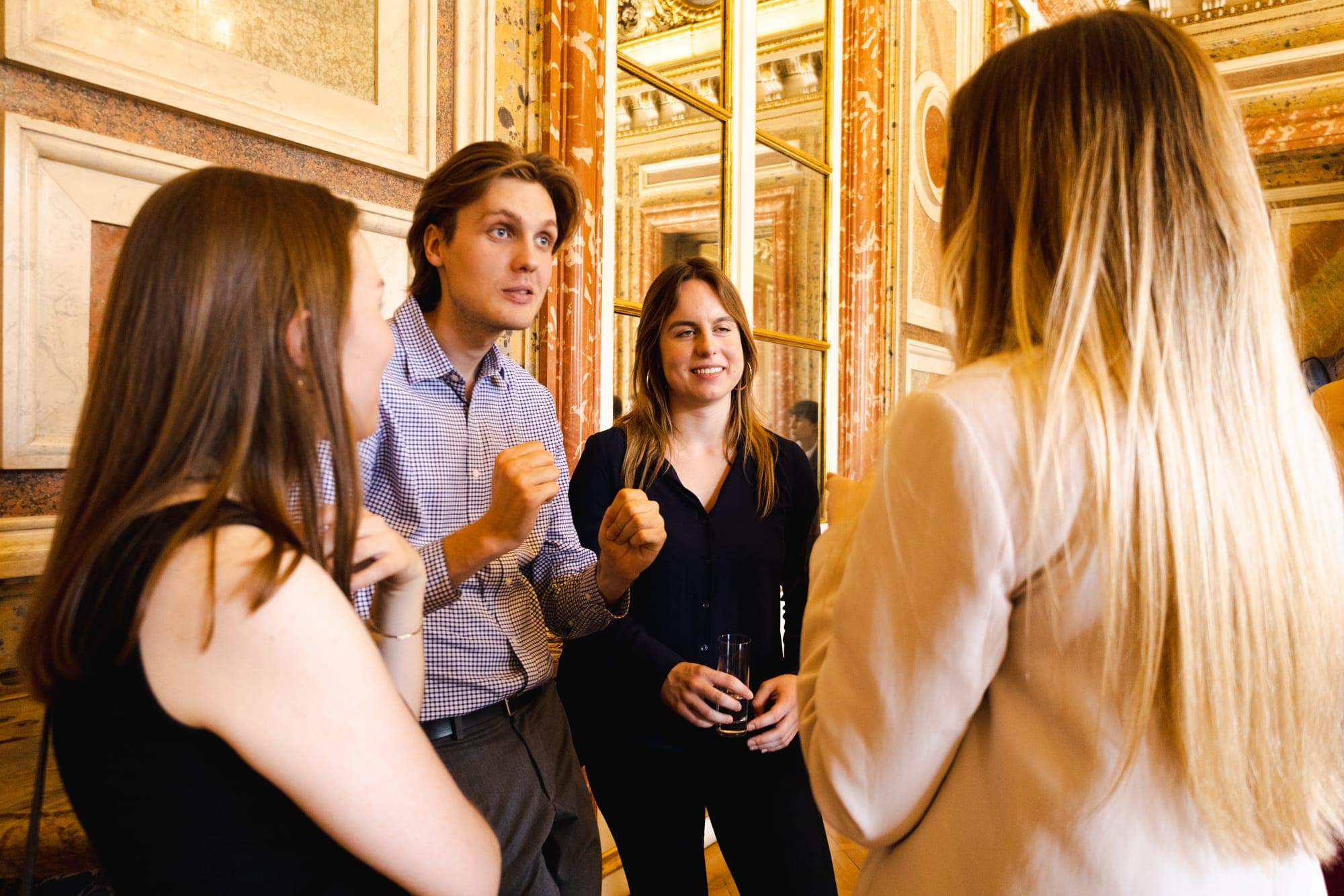 Students talking in a small group during the reception