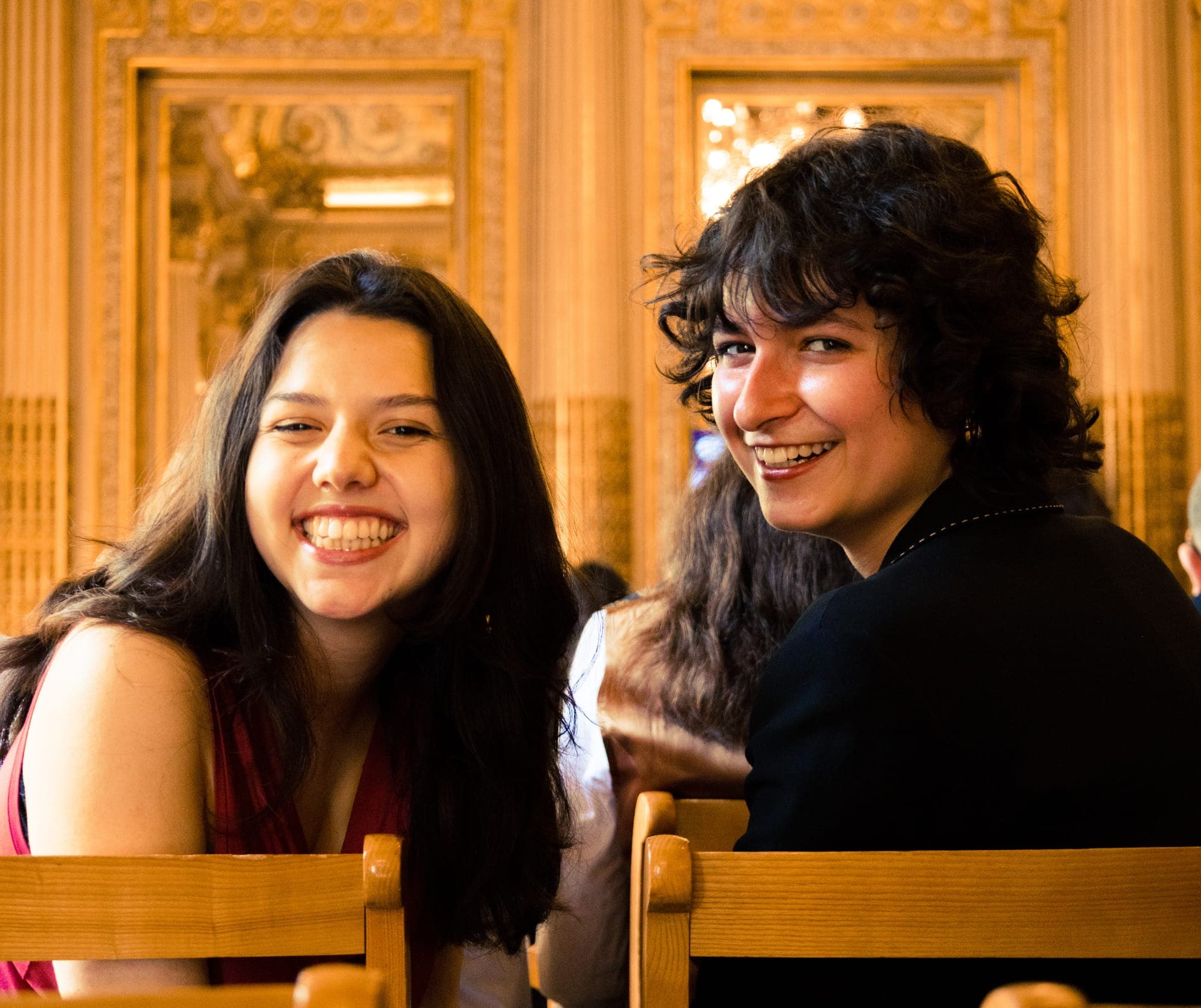 Two smiling guests turning to the camera